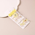 Detail shot of heart, flower and pearl hair clips set in a clean minimalist display - Yellow Collection (Style A)