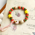 Handmade ceramic and wood bead bracelet with a pink woven tassel on vintage paper - Pink Apple Tassel Style (1616-02) / Pink