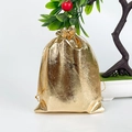 Metallic gold drawstring gift pouch for jewelry packaging on a white surface - 7x9cm / Gold
