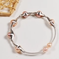 Close-up of handmade freshwater pearl wire-wrapped bracelet with pink pearls and silver wire - Silver Pink Pearl Wire Wrapped Bangle