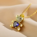 Macro shot of teddy bear pendant with purple heart stone and micro-pave zircons - Purple