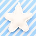 White leather star keychain with fine stitching and silver ring on a striped background - White
