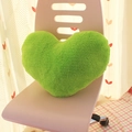 Green heart-shaped plush pillow placed on a pink chair for modern sofa decor - Green Stone Heart