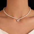 Elegant pearl necklace featuring a pink butterfly pendant worn by a model in warm light - Pink Butterfly Pendant Pearl Necklace