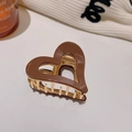 Detailed view of coffee brown heart-shaped acetate hair claw with gold metal spring - Coffee