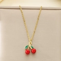 Close-up of golden necklace featuring a red enamel cherry pendant with green leaves - Enamel Red Green Cherry Flat Lay Style (KN292079-Z)