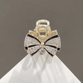 Exquisite golden bow hair claw clip with rhinestones and black borders on white stand - Gold Bow Rhinestone Claw Clip