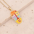 Macro shot of 18K gold plated abstract face pendant with colorful enamel details - Colorful Abstract Face B