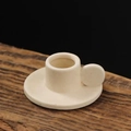 Minimalist white ceramic candle holder with circular handle on a rustic wood surface - Wenxin Cup Candlestick / Beige