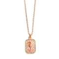 Detailed close-up of golden seahorse pendant with pink enamel and sparkling zirconias - Seahorse Necklace
