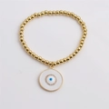 Dettaglio del bracciale elastico a sfere dorate con pendente malocchio blu e zirconi - 0471 Malocchio Disco Bianco