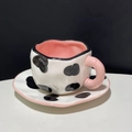 Irregular ceramic coffee cup and saucer set with black cow pattern and pink interior - Cow Print Cup & Saucer