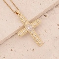 Macro shot of a gold-plated 18K cross pendant with micro-paved sparkling zircon stones - White