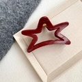 Detailed view of a dark red star-shaped hair claw clip on a beige textured tray - Wine Red - Star Shape Claw (11cm)