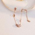Elegant 18k rose gold bracelet featuring a paved zircon cylinder charm and lobster clasp - Three-Stone Zircon Bracelet