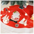 Close-up of red plush Christmas tree skirt with Santa Claus applique and white snowy edge - Red Santa Claus Style / 90cm