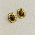 Detail showing vintage gold-plated oval stud earrings with brown tiger eye stone inlay - Gold Inlaid Tiger Eye Color