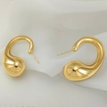 Macro shot of polished gold water drop earrings on textured white fabric background - Polished Streamline Drop Style (XL1464-56)