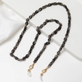 Detail of smoky gray acrylic eyeglass chain with gold lobster clasp and silicone loop - Smoke