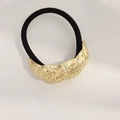 Elastic hair tie with hammered gold metal detail in minimalist black design - Twist Pattern Gold