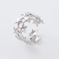 Detail showing polished silver hollow star patterns on this adjustable open ring design - Steel