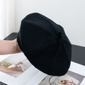 Detail of black knit beret showing textured wool fabric held against a minimal background - M (56-58cm) / Black