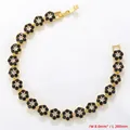 Detail of 8.0mm wide gold floral tennis bracelet with black and clear zircons - Gold Black Zirconia Bracelet (VL527)
