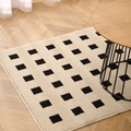 Modern black and white checkered entryway rug on wooden floor for a minimalist home decor - 50x80cm / White Grid