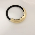 Minimalist elastic hair tie featuring a large curved gold metal piece in polished finish - Single Layer Curved Gold