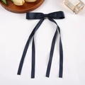 Elegant navy blue ribbon bow hair clip with long streamers on a clean white background - Navy Blue