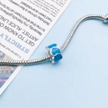 Silver snake chain bracelet featuring a blue enamel heart-shaped charm and pendant - Lake Blue