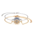 Detail of sun and moon pendants featuring blue and clear crystals on silver and gold chains - Sun Moon Bracelet Set