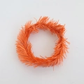 Macro view of orange PVC pine needle candle ring for Christmas wreath decoration - 10cm Orange Tinsel Ring