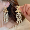 Elegant gold leaf earrings with long white pearl tassels worn by a female model - 44# Silver Earring Post-Golden-White Maple Leaf