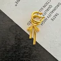 Detailed close-up of a vintage-style golden butterfly ear cuff on a textured background - Matte Bow Ear Clip Style (7#) / Gold