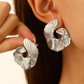 Close-up of silver irregular fan-shaped earrings with abstract shell texture on a model - Abstract Vortex Shape Silver (12185)