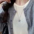 Detail of silver spherical pendant necklace on a knit sweater, minimalist jewelry style - Silver Spherical Style (54#)