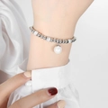 Luxurious geometric beaded bracelet with silver finish and centered white pearl charm - Pearl Pendant / Steel