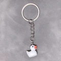 Detailed close-up of a 3D resin duck charm attached to a silver metal keychain ring - 28mm Ring / White