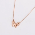 Detailed close-up of rose gold double-layered butterfly necklace with hollow texture - Necklace / Rose Gold