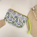 Detailed view of a floral makeup bag featuring purple tulips and a neon green braided strap - Bubble Tulip Blue Purple