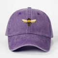 Close-up of embroidered bee on washed purple cotton baseball cap with fabric texture - One Size / Purple