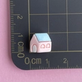 Miniature pink and blue resin house charm shown with scale ruler for 1cm size reference - Pink House