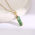 Macro view of a gold water wave chain featuring a green bamboo pendant with zircon - Golden Green Bamboo