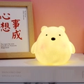Cute bear shaped night light with warm yellow glow made of soft silicone material - Small Bear Night Light