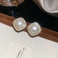 Nahaufnahme eleganter Vintage-Ohrringe mit einer Perle und funkelnder Zirkonia-Einfassung. - Ohrstecker / Beige / Gold