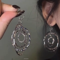 Close-up of textured triple-layer circular drop earrings in silver finish - Hook Style / Silver