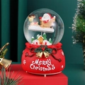 Detail view of a Christmas crystal ball music box featuring Santa Claus and a gift bag base - 2136Y Deer / 80# Light + Music