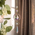 Macro shot of gold suncatcher crystal prisms reflecting rainbow light in the garden - Amethyst Stone Circle