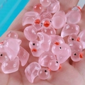 Luminous pink resin duck miniatures for DIY crafts and car decor held in hand - Light Pink
